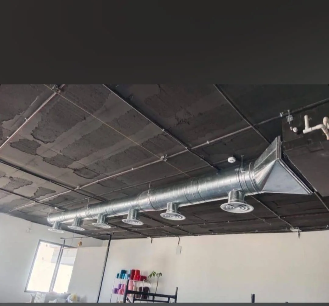 Exposed round duct with ceiling diffusers